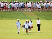 Jon Rahm of Barrika, Spain and Patrick Rodgers of Jupiter, Florida walk on the 18th fairway during The Memorial Tournament presented by Work...