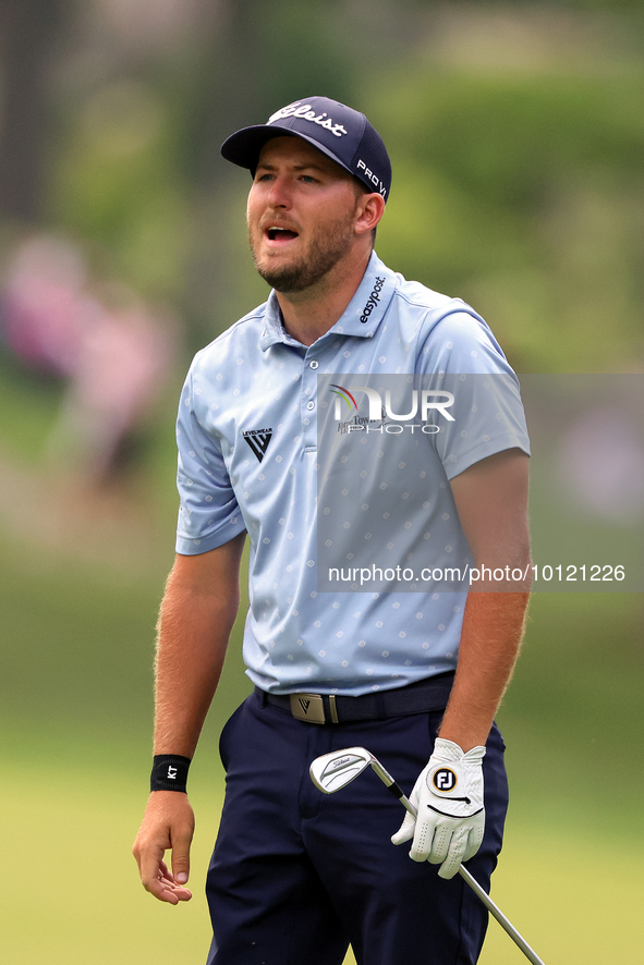 Patrick Rodgers of Jupiter, Florida reacts to his shot from the 18th fairway during The Memorial Tournament presented by Workday at Muirfiel...