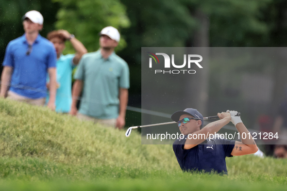 Rickie Fowler of Murrieta, California hits from the bunker on the 18th fairway during The Memorial Tournament presented by Workday at Muirfi...