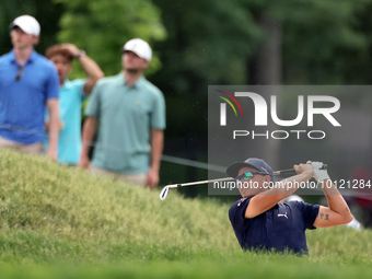 Rickie Fowler of Murrieta, California hits from the bunker on the 18th fairway during The Memorial Tournament presented by Workday at Muirfi...