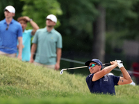 Rickie Fowler of Murrieta, California hits from the bunker on the 18th fairway during The Memorial Tournament presented by Workday at Muirfi...