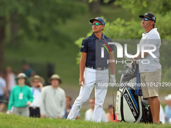 Rickie Fowler of Murrieta, California follows his shot from the bunker on the 18th fairway during The Memorial Tournament presented by Workd...