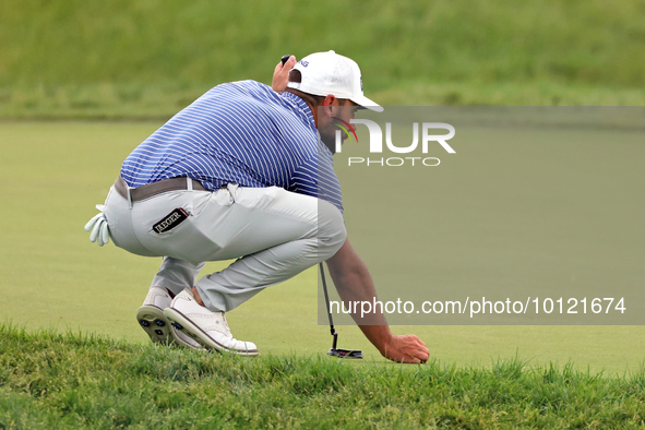 Stephan Jaeger of Germany places his ball on the 18th green during The Memorial Tournament presented by Workday at Muirfield Village Golf Cl...