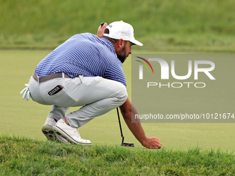 Stephan Jaeger of Germany places his ball on the 18th green during The Memorial Tournament presented by Workday at Muirfield Village Golf Cl...