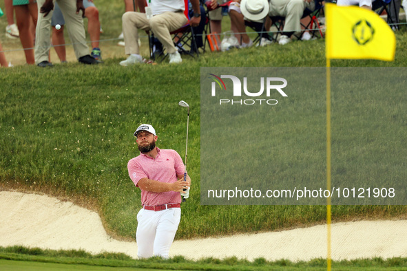 Terrell Hatton of High Wycombe, England hits from the bunker on the 18th green during The Memorial Tournament presented by Workday at Muirfi...