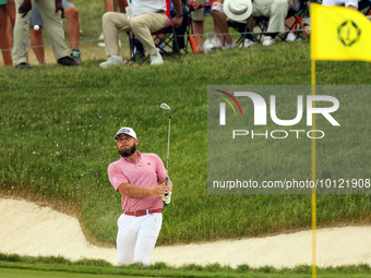 Terrell Hatton of High Wycombe, England hits from the bunker on the 18th green during The Memorial Tournament presented by Workday at Muirfi...