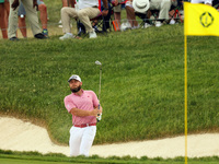 Terrell Hatton of High Wycombe, England hits from the bunker on the 18th green during The Memorial Tournament presented by Workday at Muirfi...