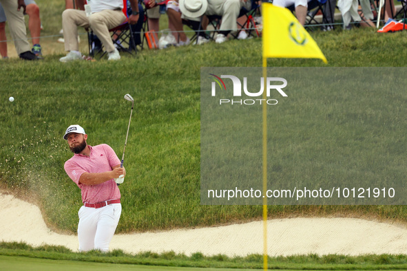 Terrell Hatton of High Wycombe, England hits from the bunker on the 18th green during The Memorial Tournament presented by Workday at Muirfi...