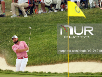 Terrell Hatton of High Wycombe, England hits from the bunker on the 18th green during The Memorial Tournament presented by Workday at Muirfi...