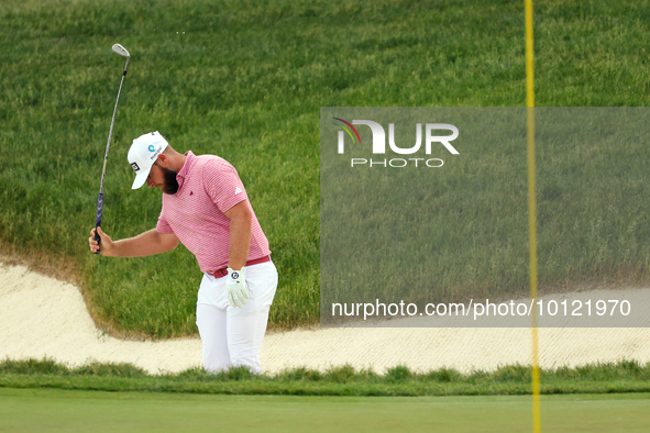 Tyrrell Hatton of High Wycombe, England reacts to his shot from the bunker on the 18th green during The Memorial Tournament presented by Wor...