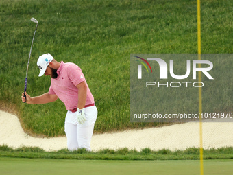 Tyrrell Hatton of High Wycombe, England reacts to his shot from the bunker on the 18th green during The Memorial Tournament presented by Wor...