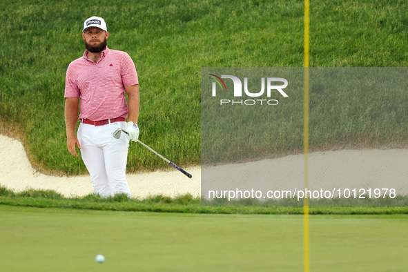 Tyrrell Hatton of High Wycombe, England follows his shot from the bunker on the 18th green during The Memorial Tournament presented by Workd...