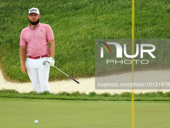 Tyrrell Hatton of High Wycombe, England follows his shot from the bunker on the 18th green during The Memorial Tournament presented by Workd...