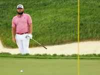 Tyrrell Hatton of High Wycombe, England follows his shot from the bunker on the 18th green during The Memorial Tournament presented by Workd...