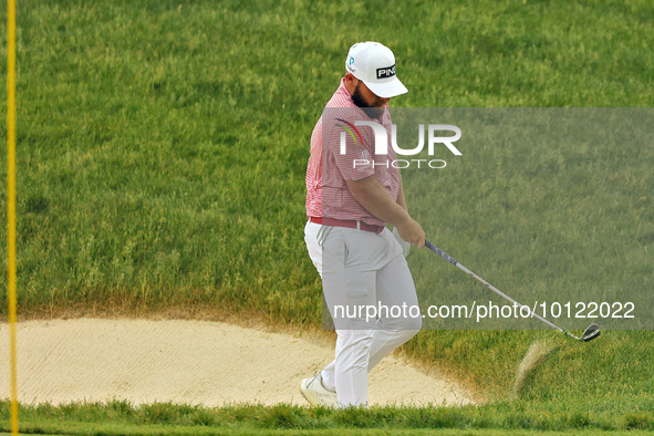 Tyrrell Hatton of High Wycombe, England reacts to his shot from the bunker on the 18th green during The Memorial Tournament presented by Wor...