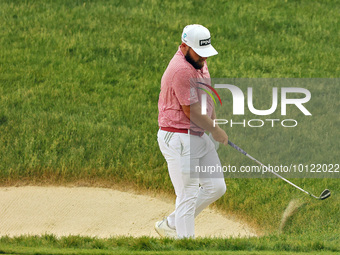 Tyrrell Hatton of High Wycombe, England reacts to his shot from the bunker on the 18th green during The Memorial Tournament presented by Wor...