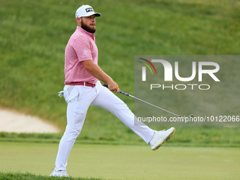 Tyrrell Hatton of High Wycombe, England reacts to his putt on the 18th green during The Memorial Tournament presented by Workday at Muirfiel...