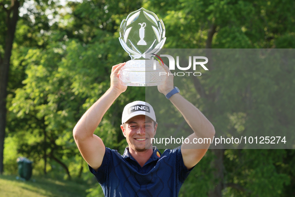 Viktor Hovland of Oslo, Norway holds up the winner’s trophy after winning in a playoff against Denny McCarthy of Jupiter, Florida during the...