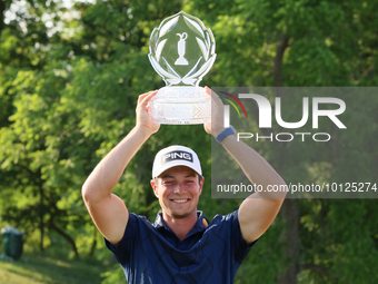 Viktor Hovland of Oslo, Norway holds up the winner’s trophy after winning in a playoff against Denny McCarthy of Jupiter, Florida during the...