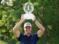 Viktor Hovland of Oslo, Norway holds up the winner’s trophy after winning in a playoff against Denny McCarthy of Jupiter, Florida during the...