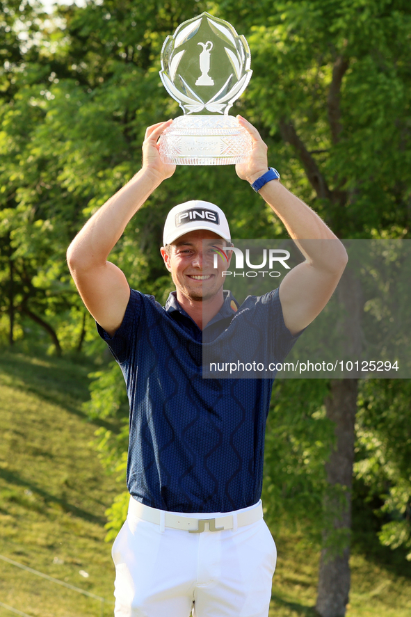 Viktor Hovland of Oslo, Norway holds up the winner’s trophy after winning his first tournament in the United States in a playoff against Den...