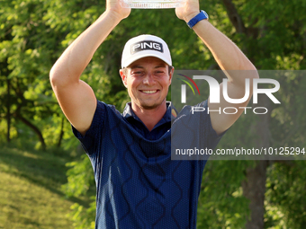 Viktor Hovland of Oslo, Norway holds up the winner’s trophy after winning his first tournament in the United States in a playoff against Den...