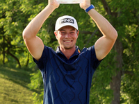 Viktor Hovland of Oslo, Norway holds up the winner’s trophy after winning his first tournament in the United States in a playoff against Den...