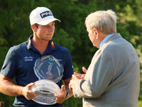 Jack Nicklaus speaks with Viktor Hovland of Oslo, Norway as he holds the winner’s trophy after winning his first tournament in the United St...