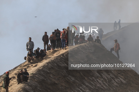 PROBOLINGGO, INDONESIA - JUNE 5: Tenggerese walk and hike carrying agricultural products and livestock to be sacrificed during the Yadnya Ka...