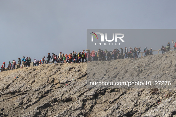 PROBOLINGGO, INDONESIA - JUNE 5: Tenggerese walk and hike carrying agricultural products and livestock to be sacrificed during the Yadnya Ka...