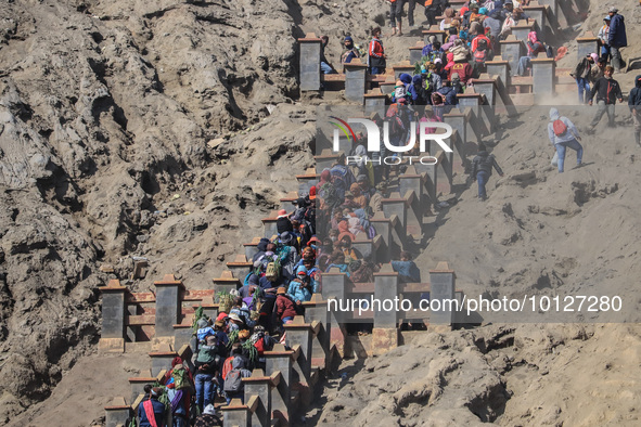 PROBOLINGGO, INDONESIA - JUNE 5: Tenggerese walk and hike carrying agricultural products and livestock to be sacrificed during the Yadnya Ka...