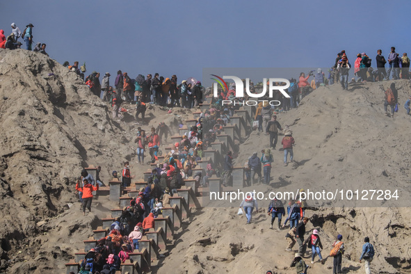 PROBOLINGGO, INDONESIA - JUNE 5: Tenggerese walk and hike carrying agricultural products and livestock to be sacrificed during the Yadnya Ka...