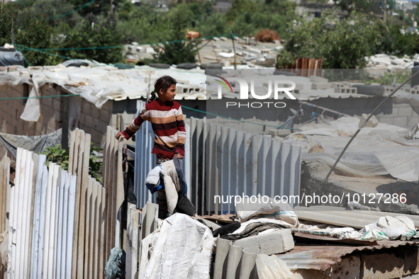 A Palestinian girl stands on the roof of her family's house in a poor neighborhood in Beit Lahia in the northern Gaza Strip, on June 5, 2023...