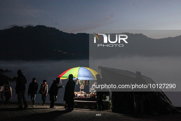 PROBOLINGGO, INDONESIA - JUNE 5: Tenggerese walk and hike carrying agricultural products and livestock to be sacrificed during the Yadnya Ka...