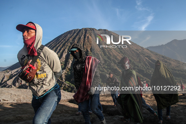 PROBOLINGGO, INDONESIA - JUNE 5: Tenggerese walk and hike carrying agricultural products and livestock to be sacrificed during the Yadnya Ka...