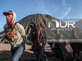 PROBOLINGGO, INDONESIA - JUNE 5: Tenggerese walk and hike carrying agricultural products and livestock to be sacrificed during the Yadnya Ka...