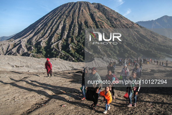 PROBOLINGGO, INDONESIA - JUNE 5: Tenggerese walk and hike carrying agricultural products and livestock to be sacrificed during the Yadnya Ka...