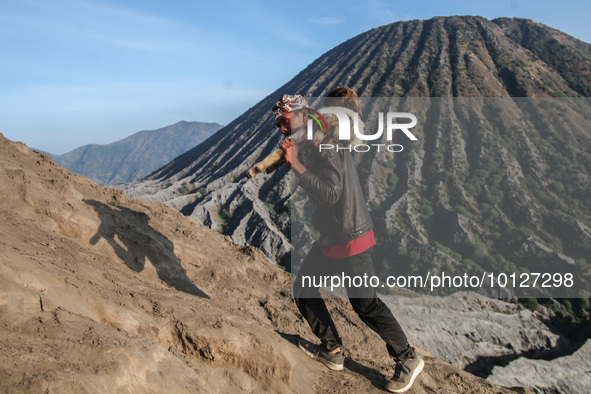 PROBOLINGGO, INDONESIA - JUNE 5: Tenggerese walk and hike carrying agricultural products and livestock to be sacrificed during the Yadnya Ka...