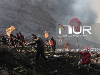 PROBOLINGGO, INDONESIA - JUNE 5: Tenggerese walk and hike carrying agricultural products and livestock to be sacrificed during the Yadnya Ka...