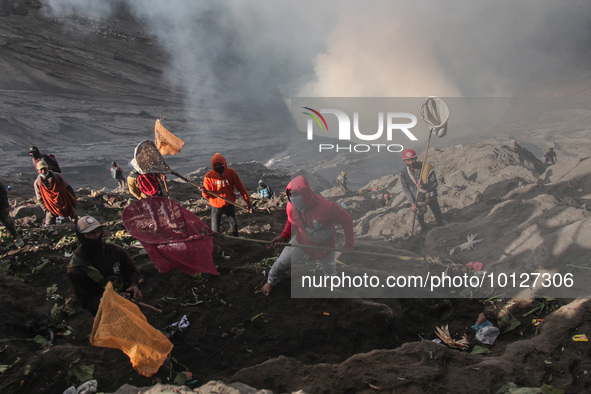 PROBOLINGGO, INDONESIA - JUNE 5: Tenggerese walk and hike carrying agricultural products and livestock to be sacrificed during the Yadnya Ka...