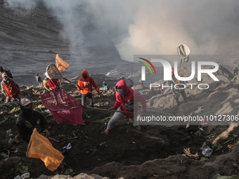 PROBOLINGGO, INDONESIA - JUNE 5: Tenggerese walk and hike carrying agricultural products and livestock to be sacrificed during the Yadnya Ka...