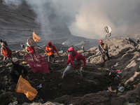 PROBOLINGGO, INDONESIA - JUNE 5: Tenggerese walk and hike carrying agricultural products and livestock to be sacrificed during the Yadnya Ka...