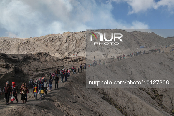 PROBOLINGGO, INDONESIA - JUNE 5: Tenggerese walk and hike carrying agricultural products and livestock to be sacrificed during the Yadnya Ka...