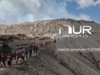 PROBOLINGGO, INDONESIA - JUNE 5: Tenggerese walk and hike carrying agricultural products and livestock to be sacrificed during the Yadnya Ka...