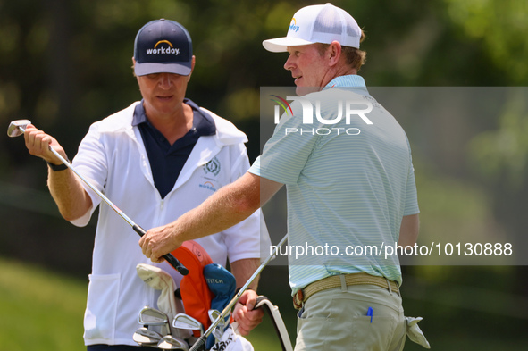 Brandt Snedeker of Franklin, Tennessee takes his club from his caddy at the 17th hole during The Memorial Tournament presented by Workday at...