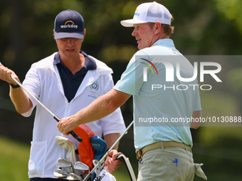 Brandt Snedeker of Franklin, Tennessee takes his club from his caddy at the 17th hole during The Memorial Tournament presented by Workday at...