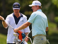 Brandt Snedeker of Franklin, Tennessee takes his club from his caddy at the 17th hole during The Memorial Tournament presented by Workday at...