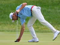 Sam Bennett of Madisonville, Texas places his ball on the 17th green during The Memorial Tournament presented by Workday at Muirfield Villag...