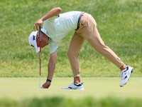 Eric Cole of Delray Beach, Florida places his ball on the 17th green during The Memorial Tournament presented by Workday at Muirfield Villag...