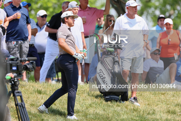 Garrick Higgo of Stellenbosch, South Africa follows his shot from the rough near the spectators during The Memorial Tournament presented by...